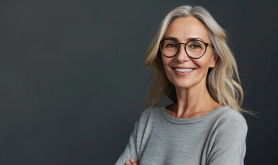 Fototapeta premium Middle aged woman wearing casual standing against neutral gray background and looking at camera