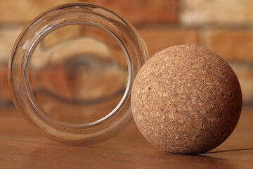 Ball made from wood processing waste on a brown background