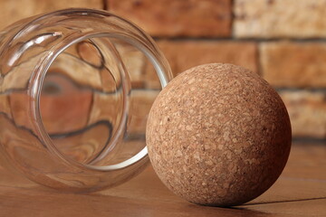Ball made from wood processing waste on a brown background