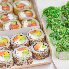 Assorted Sushi Box and Plate of Vegetables