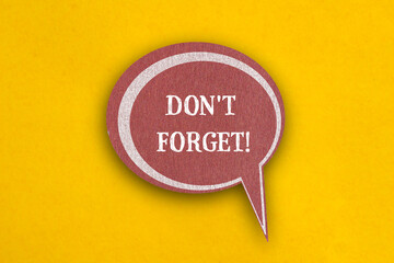 Don't forget words written on paper speech bubble with yellow background. Copy space.