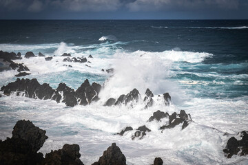waves crashing on natural lava swimming pools of porto moniz, madeira, atlantic ocean, portugal, europe, storm, waves, lava
