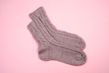 knitted wool socks on a pink background