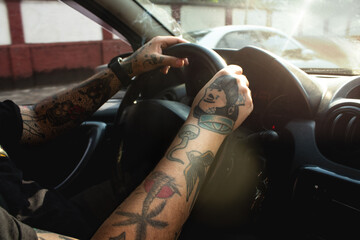 Car Interior with Tattooed Man Behind the Wheel