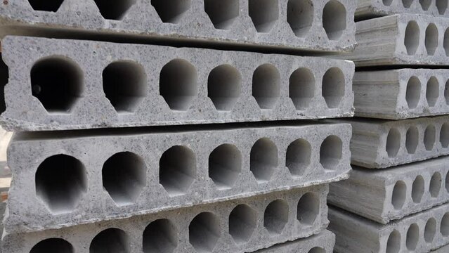 Stack of Prefabricated concrete slabs with hole for construction. Plant of reinforced concrete structures warehouse concrete products
