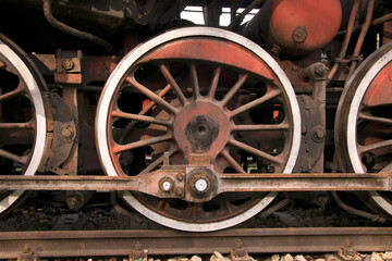 Fototapeta na wymiar Red wheel of a heavy locomotive