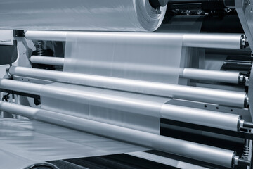 Automatic polyethylene plastic bag production machine with lighting effect. Close-up of the roller...