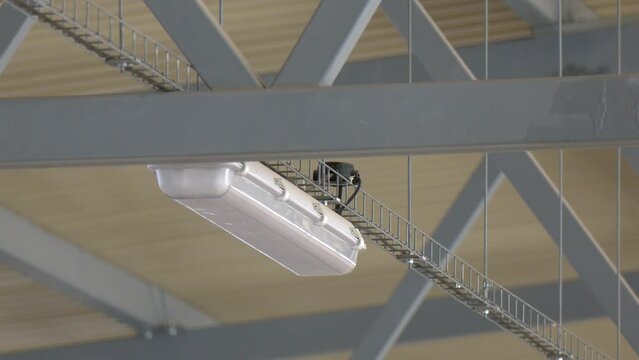 Metal structure of the roof frame in an industrial hangar. Bottom-up view. Close-up.  installation of lighting fixtures suspended ceiling and Lighting equipment