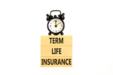 Term life insurance symbol. Concept words Term life insurance on beautiful wooden blocks. Beautiful white table white background. Black alarm clock. Medical term life insurance concept. Copy space.