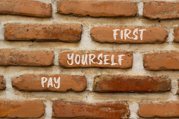 Pay yourself first symbol. Concept words Pay yourself first on beautiful brown brick. Beautiful brown brick wall background. Business and pay yourself first concept. Copy space.
