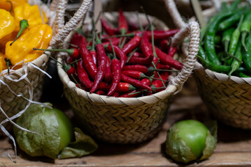 display of red and green chillies in baskets