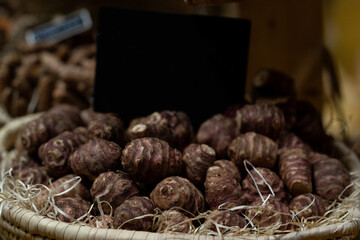 detail of tupinambo root in a market with a sign