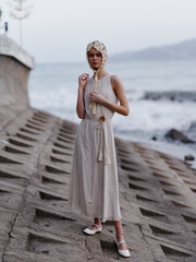 Stylish Summer Beauty: Fashionable Lady Posing in White Dress by the Ocean