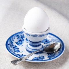 white boiled egg on plate with metal tea-spoon