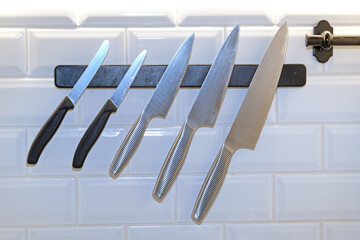 sharp kitchen knife on black magnetic holder