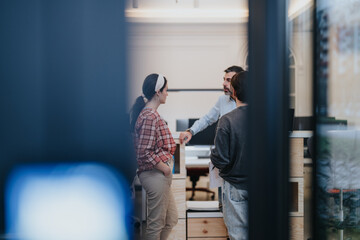 Two professionals exchange greetings with a handshake through the door of a contemporary workspace, symbolizing a business meeting or agreement.