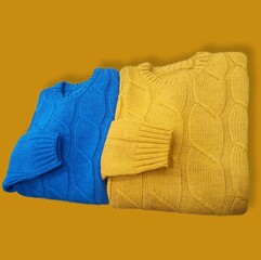 folded bright blue and yellow sweater on isolated background