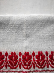 Gamosa or gamusa is a traditional textile pattern from Assam. It is a white piece of cloth with red stripes and red motifs, which is used in Bihu and resembles Ukrainian and Russian patterns. - obrazy, fototapety, plakaty