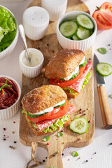 Delicious and fresh sandwich with salami, vegetables and mayonnaise.