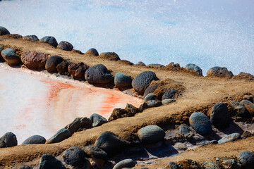 Gran Canaria, Salinas de Tenefe salt evaporation ponds, southeastern part of the island, pink color created by Dunaliella salina algae - 727370358