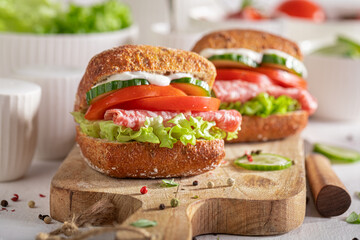 Fresh and homemade sandwich with salami, tomato and cucumber.
