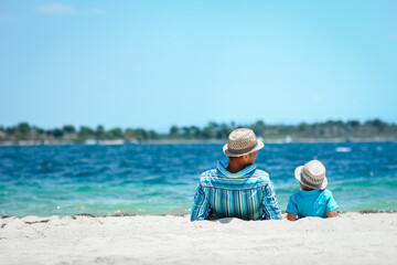 A happy father with a child by the sea in nature weekend travel