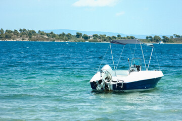 Fototapeta premium A beautiful boat floating on the background of the sea silhouette