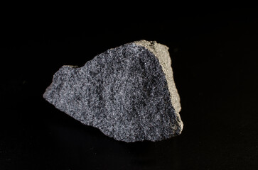 Chromite stone mineral greenish-gray color on dark background