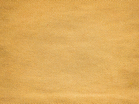 old khadi fabric texture background. light natural linen texture for the background.Golden yellow linen fabric of table cloth texture background.