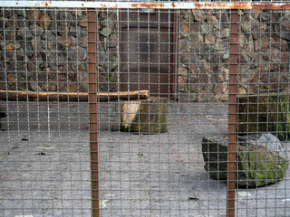 Outdoor fence at the zoo. Empty cages in the zoo. Winter at the zoo. The animals hid. Empty animal...
