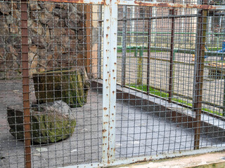 Outdoor fence at the zoo. Empty cages in the zoo. Winter at the zoo. The animals hid. Empty animal...