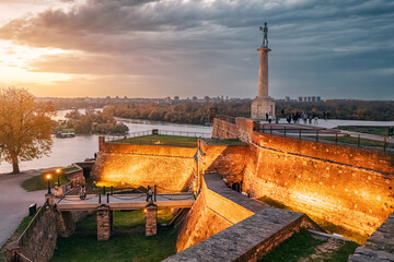 As the sun sets, Belgrade's Kalemegdan fortress comes alive with illumination, a captivating sight for tourists and travelers. - obrazy, fototapety, plakaty