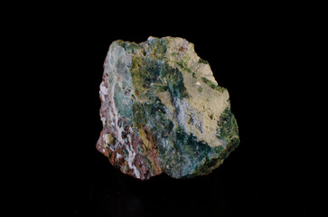 HEULANDITE stone is a green mineral on a dark background.