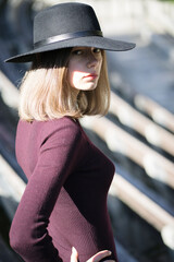 A lonely girl in a black hat