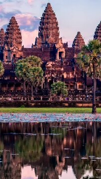 Timelapse of Cambodia landmark Angkor Wat with reflection in water. Camera zoom out