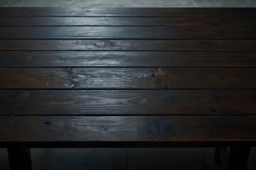 View from above of dark wooden table with light shining on it
