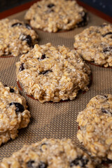 Healthy oatmeal cookies for breakfast. Cookies made from banana, oat flakes, dried cranberries and natural seeds and seeds. the process of baking cookies