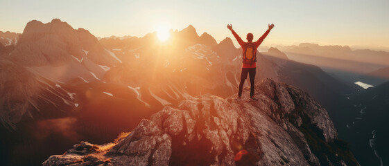 Summit success: A hiker celebrates atop a mountain, basking in the glory of the sunrise