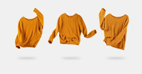 Set of yellow orange flying sweaters isolated. Women's trendy clothing. Knitwear. Woolen female...