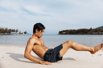 Fototapeta na wymiar Active Asian Athlete Embracing Fitness on Sandy Beach during Summer Sunset