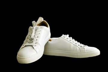 Sleek contrast: Crisp white low-tops against a bold black backdrop