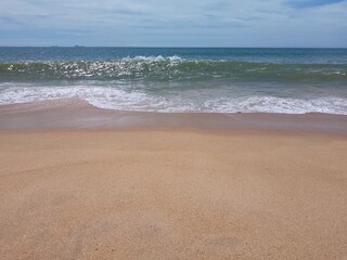 Fototapeta na wymiar Wave in the SEa on Beach and Sun