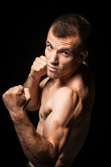 Portrait of young man in boxing pose