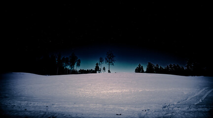 A dark and starry night in the winter landscape