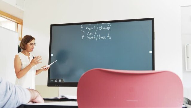 English teacher using an smart board in a high school.	
