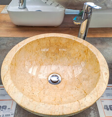 Modern interior of bathroom with marble tile, stylish washbasin