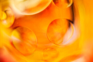 Golden yellow and orange glass orbs, abstract texture background