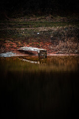 Mystery lake and forest in autumn colors . Lake in frost . Red colors . Fall on lake . House and buildings on the beach . Fishing house on the lake 
