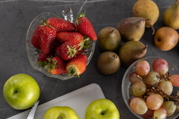fruits in studio, table served with fresh fruits, detail of apples, pears, strawberries, watermelon and grapes, ingredients for healthy diet, fresh food