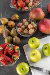 fruit wallpaper in studio, table served with fresh fruits, detail of apples, pears, strawberries, watermelon and grapes, ingredients for healthy diet, fresh food